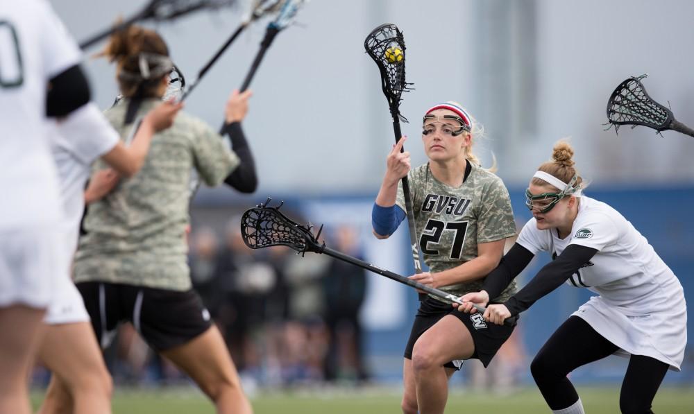 GVL / Kevin Sielaff - Danielle Tunnell (27) works her way through the Lake Erie defense and tries a shot on net. Grand Valley defeats Lake Erie College with a final score of 19-2 on Friday, April 29, 2016 in Allendale. 