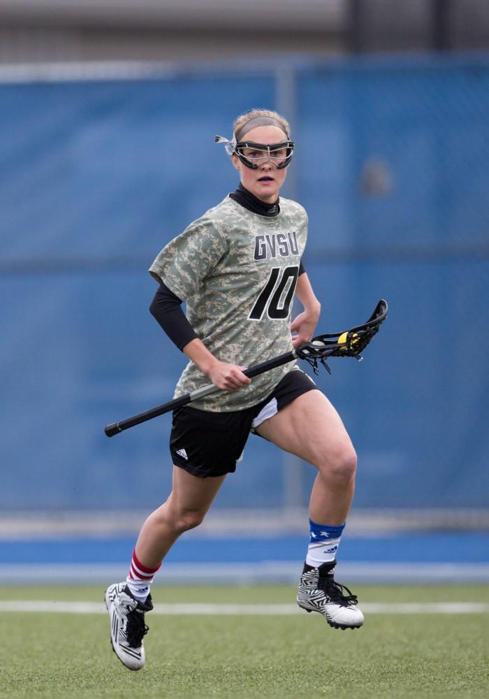 GVL / Kevin Sielaff - Chelsey Bishop (10) sprints up the field and gets some passing going for the Lakers. Grand Valley defeats Lake Erie College with a final score of 19-2 on Friday, April 29, 2016 in Allendale. 