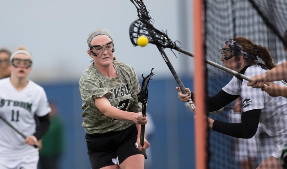 GVL / Kevin Sielaff - Erika Neumen (3) rips a shot on Lake Erie's net. Grand Valley defeats Lake Erie College with a final score of 19-2 on Friday, April 29, 2016 in Allendale. 