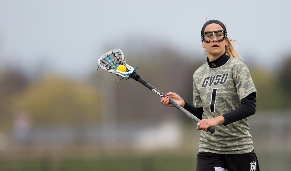 GVL / Kevin Sielaff - Ryan Skomial (1) holds the ball at the top of Lake Erie's zone and sets up a play. Grand Valley defeats Lake Erie College with a final score of 19-2 on Friday, April 29, 2016 in Allendale. 