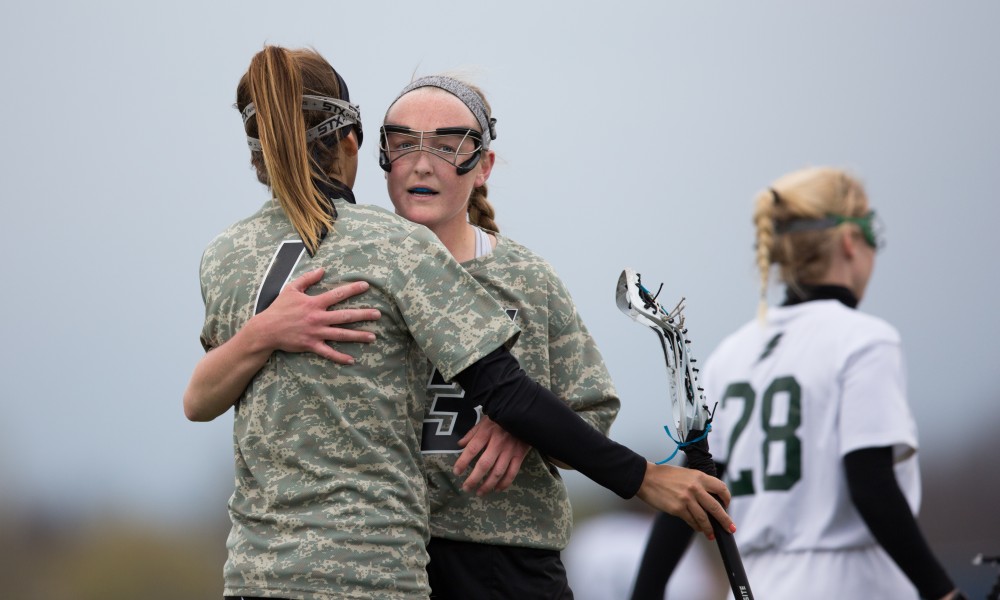 GVL / Kevin Sielaff - Ryan Skomial (1) and Erika Neumen (3) react after a goal. Grand Valley defeats Lake Erie College with a final score of 19-2 on Friday, April 29, 2016 in Allendale. 