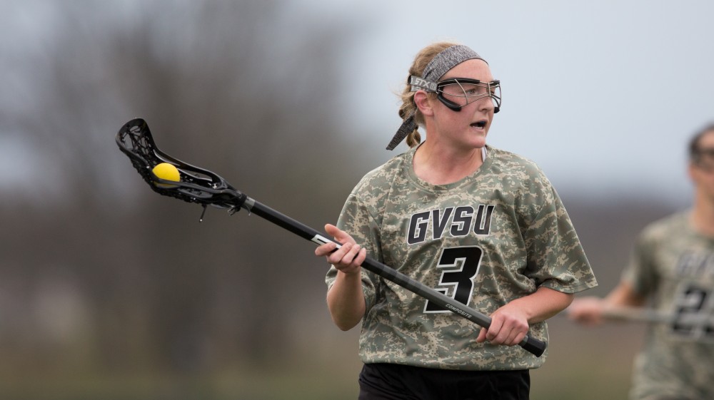 GVL / Kevin Sielaff - Erika Neumen (3) holds the ball in Lake Erie's zone and looks to pass. Grand Valley defeats Lake Erie College with a final score of 19-2 on Friday, April 29, 2016 in Allendale. 