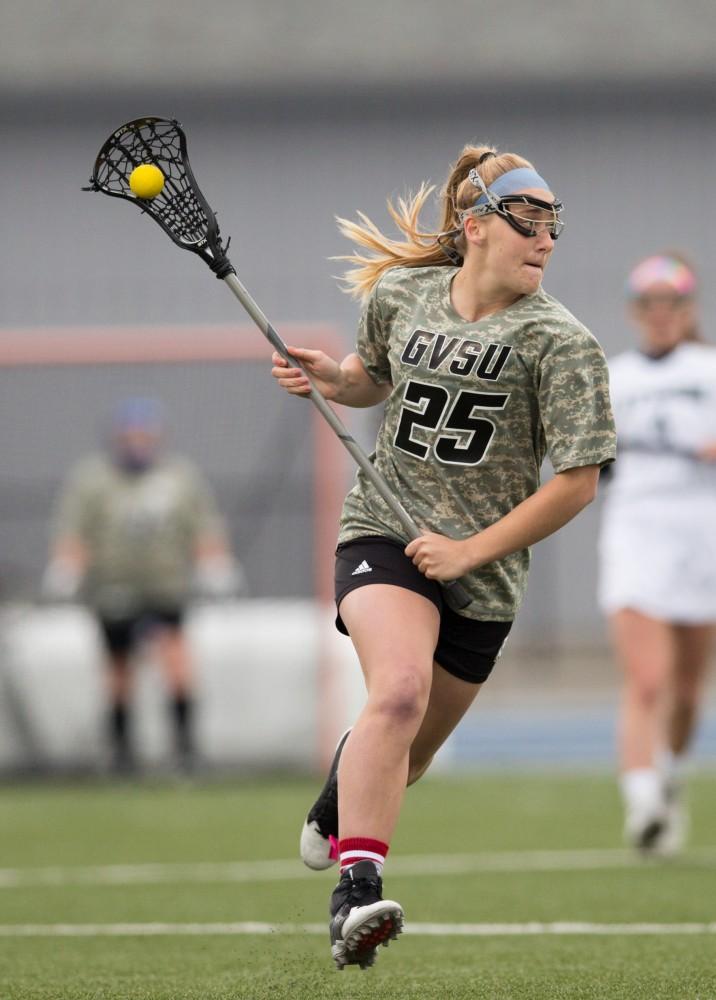 GVL / Kevin Sielaff - Carlyn Shisler (25) drives the ball up field. Grand Valley defeats Lake Erie College with a final score of 19-2 on Friday, April 29, 2016 in Allendale. 