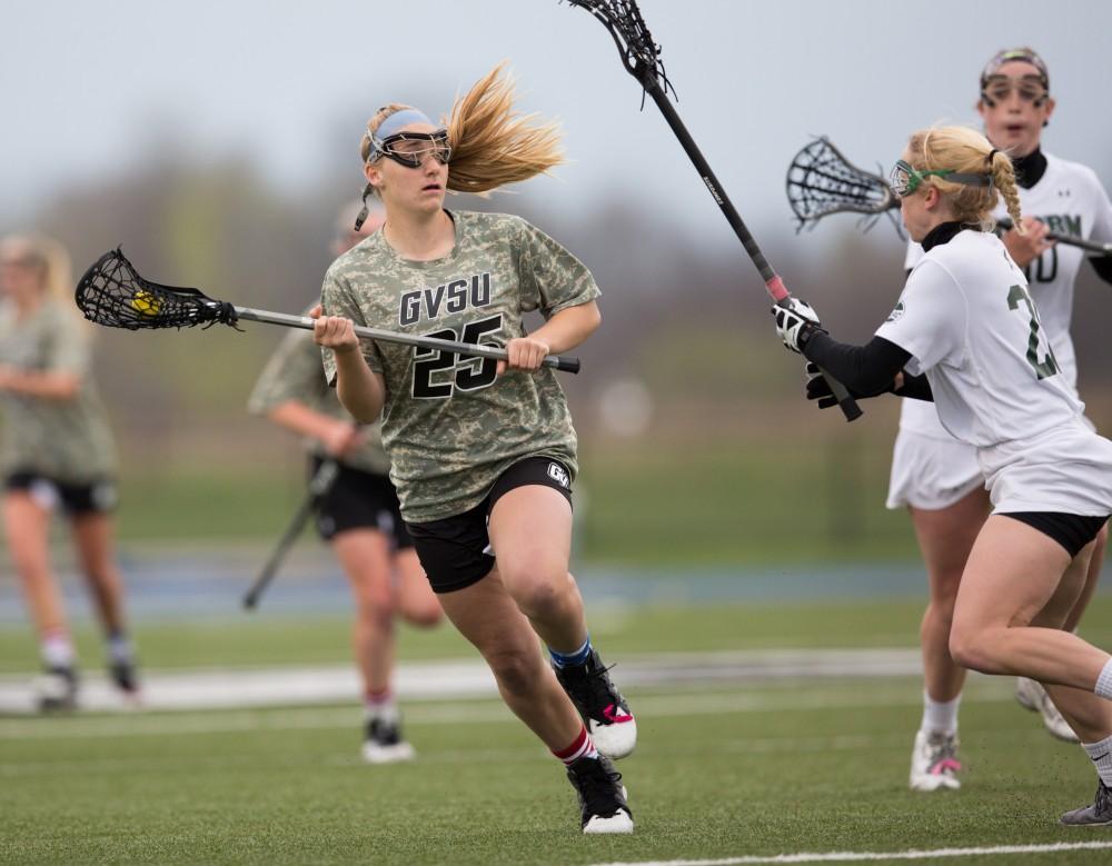 GVL / Kevin Sielaff - Carlyn Shisler(25) drives the ball up field, stops, then looks to pass. Grand Valley defeats Lake Erie College with a final score of 19-2 on Friday, April 29, 2016 in Allendale. 