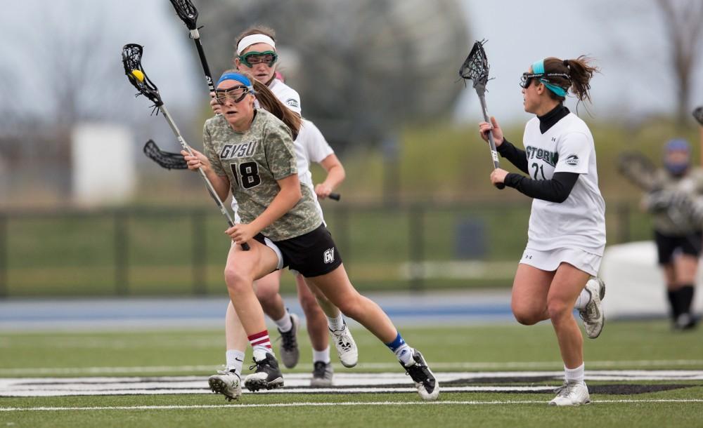 GVL / Kevin Sielaff - Meghan Datema (18) works her way up field. Grand Valley defeats Lake Erie College with a final score of 19-2 on Friday, April 29, 2016 in Allendale. 