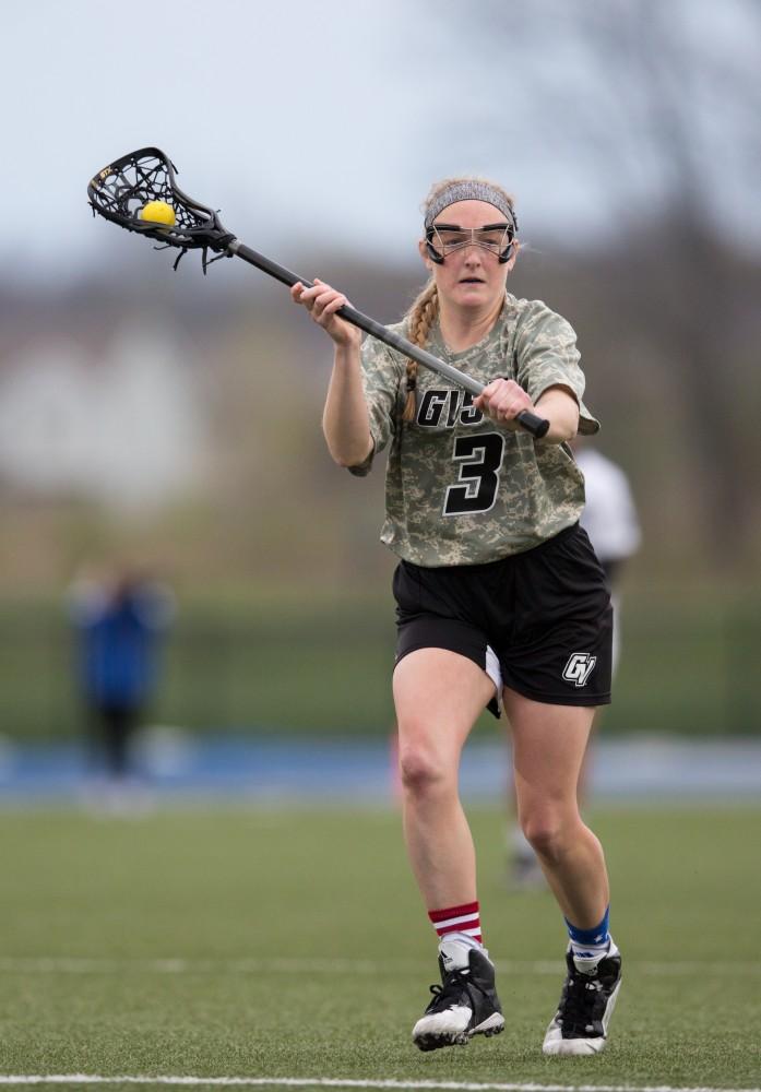 GVL / Kevin Sielaff - Erika Neumen (3) passes the ball away in Lake Erie's zone. Grand Valley defeats Lake Erie College with a final score of 19-2 on Friday, April 29, 2016 in Allendale. 