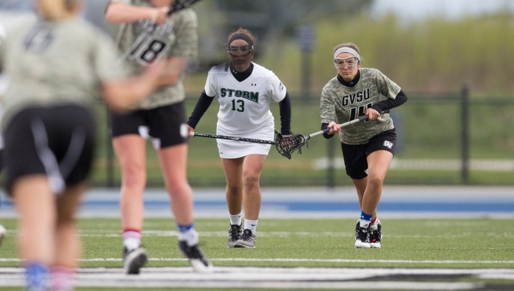 GVL / Kevin Sielaff - Chloe Zdybel (14) gets in position to receive the ball after a face off at mid-field. Grand Valley defeats Lake Erie College with a final score of 19-2 on Friday, April 29, 2016 in Allendale. 