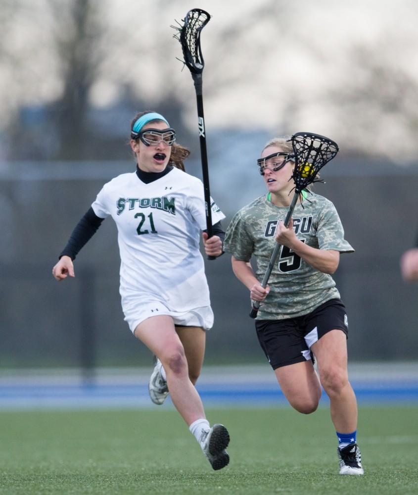 GVL / Kevin Sielaff - Kelly Leibovitz (5) sprints the entire length of the field and then passes the ball off in front of Lake Erie's net. Grand Valley defeats Lake Erie College with a final score of 19-2 on Friday, April 29, 2016 in Allendale. 