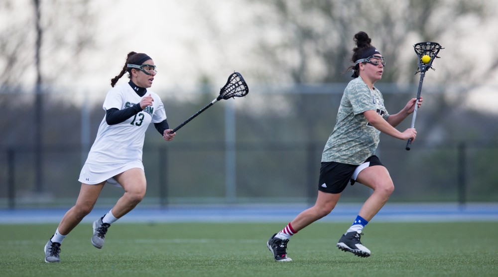 GVL / Kevin Sielaff - Caitlin Wojichowski (33) pushes the ball out of Grand Valley's zone. Grand Valley defeats Lake Erie College with a final score of 19-2 on Friday, April 29, 2016 in Allendale. 