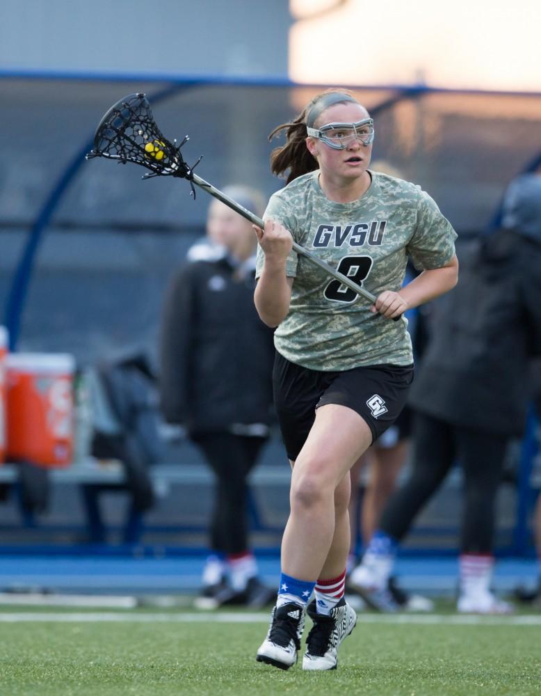 GVL / Kevin Sielaff - Livvy Mickevicius (8) pushes the ball up field. Grand Valley defeats Lake Erie College with a final score of 19-2 on Friday, April 29, 2016 in Allendale. 