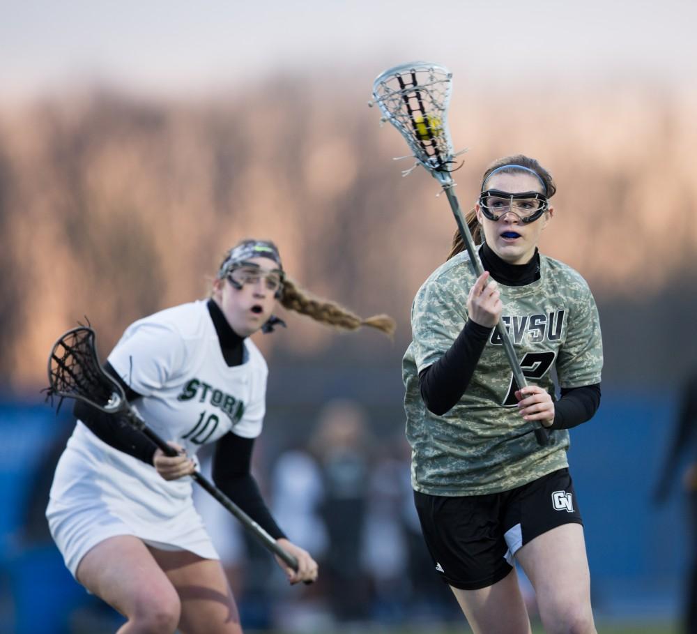 GVL / Kevin Sielaff - Elizabeth Grisko (2) moves in on Lake Erie's net as she swings past the defense. Grand Valley defeats Lake Erie College with a final score of 19-2 on Friday, April 29, 2016 in Allendale. 