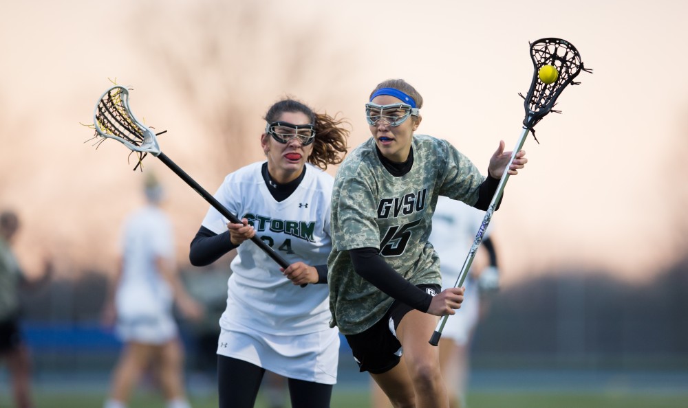 GVL / Kevin Sielaff - Meggan Loyd (15) tries a shot on net and scores. Grand Valley defeats Lake Erie College with a final score of 19-2 on Friday, April 29, 2016 in Allendale. 