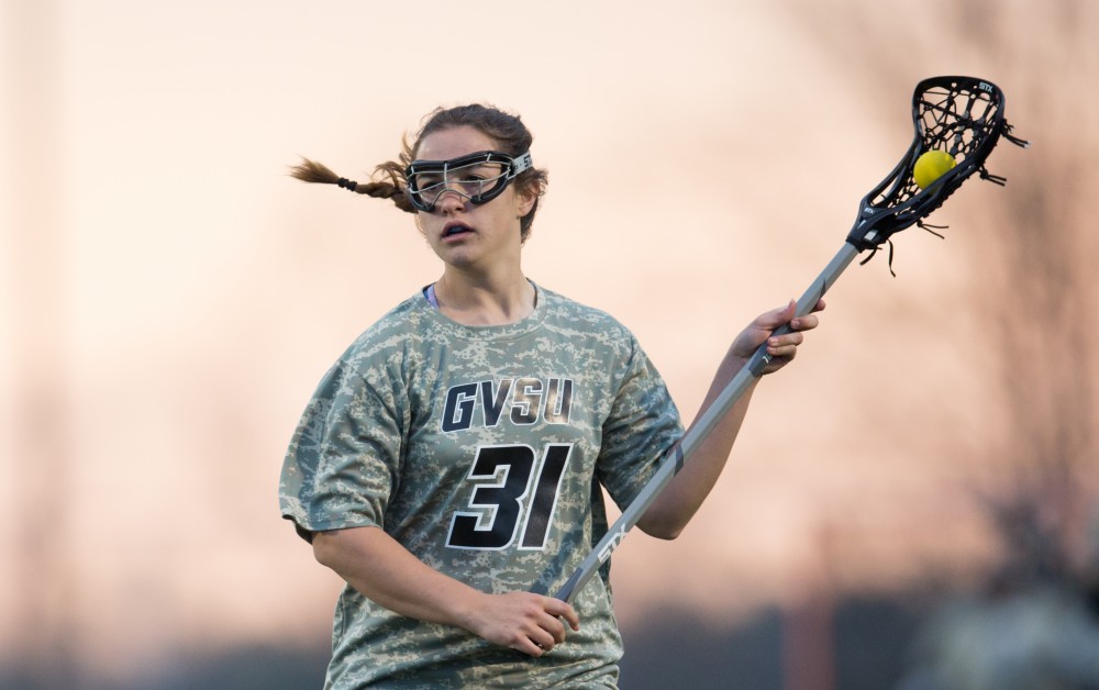 GVL / Kevin Sielaff - Carolina Reis (31) holds the ball in Lake Erie's zone. Grand Valley defeats Lake Erie College with a final score of 19-2 on Friday, April 29, 2016 in Allendale. 