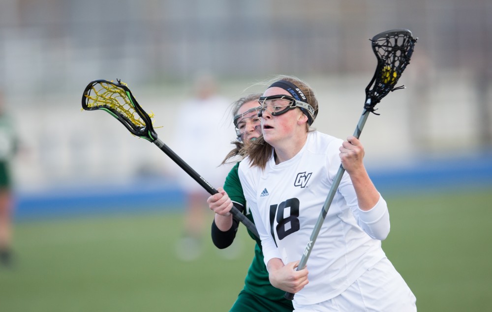 GVL / Kevin Sielaff – Meghan Datema (18) drives to Tiffin's net and tries a shot. The Lakers take the victory over Tiffin University Friday, April 1, 2016.