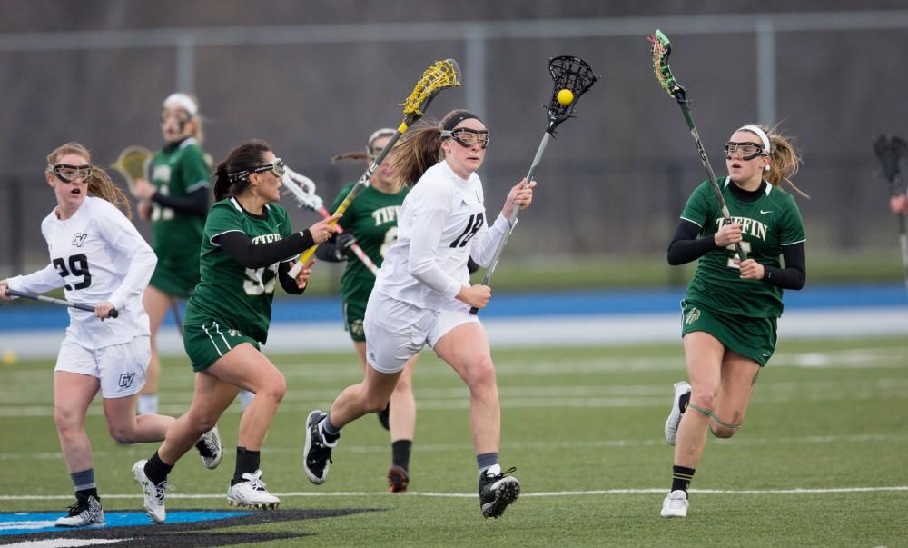 GVL / Kevin Sielaff – Meghan Datema (18) carries the ball into Tiffin's zone. The Lakers take the victory over Tiffin University Friday, April 1, 2016.