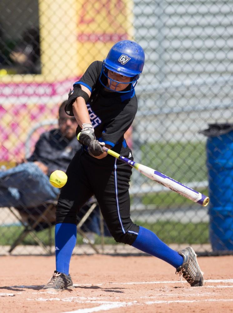 GVL / Kevin Sielaff – Teagan Shomin (9) takes a swing at an incoming pitch. Grand Valley takes the victory over Walsh in both games held in Allendale on Saturday, April 23, 2016.
