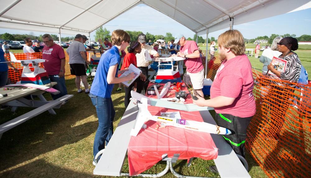 GVL / Kevin Sielaff - Students of STEPS (Science, Technology, and Engineering Day Camps) fly planes that they have built during camp at Warped Wings Fly Field in Allendale on Thursday, June 23, 2016. 