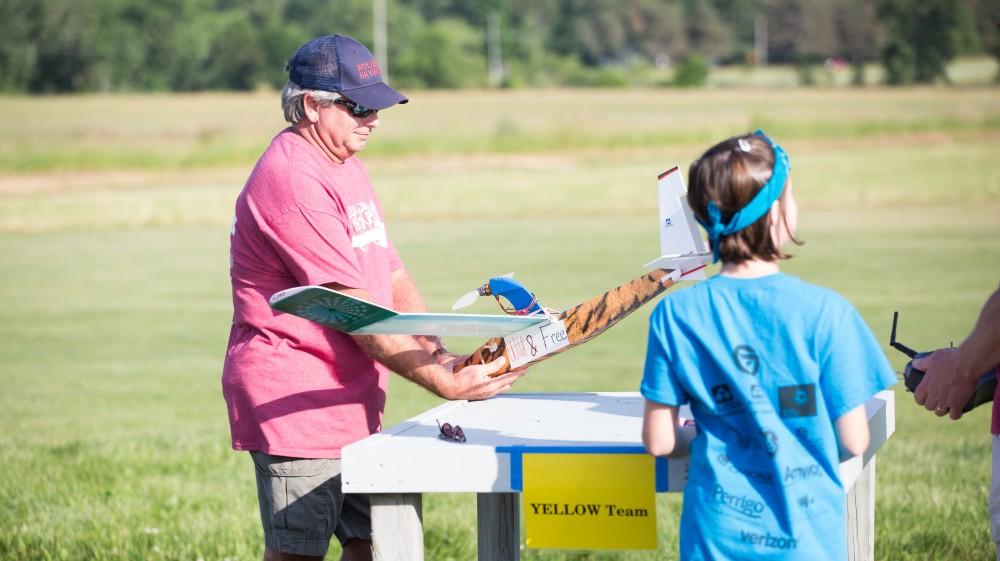 GVL / Kevin Sielaff - Students of STEPS (Science, Technology, and Engineering Day Camps) fly planes that they have built during camp at Warped Wings Fly Field in Allendale on Thursday, June 23, 2016. 