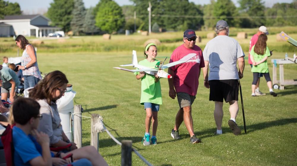 GVL / Kevin Sielaff - Students of STEPS (Science, Technology, and Engineering Day Camps) fly planes that they have built during camp at Warped Wings Fly Field in Allendale on Thursday, June 23, 2016. 