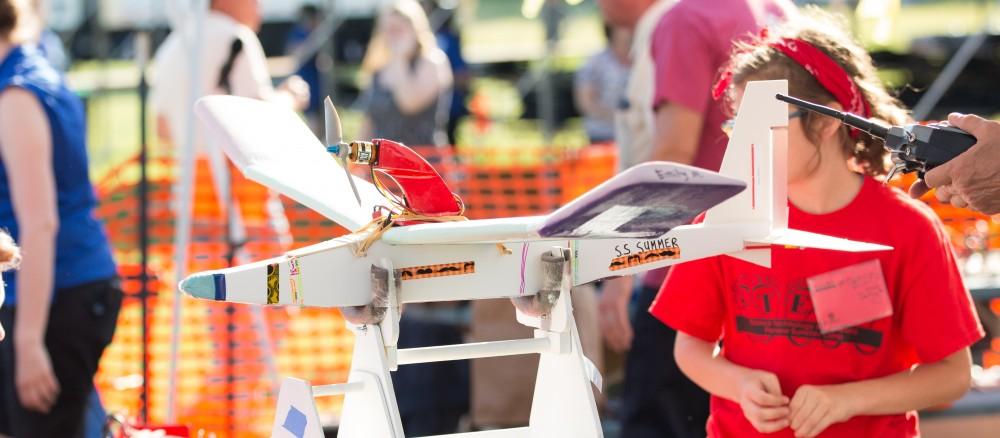 GVL / Kevin Sielaff - Students of STEPS (Science, Technology, and Engineering Day Camps) fly planes that they have built during camp at Warped Wings Fly Field in Allendale on Thursday, June 23, 2016. 