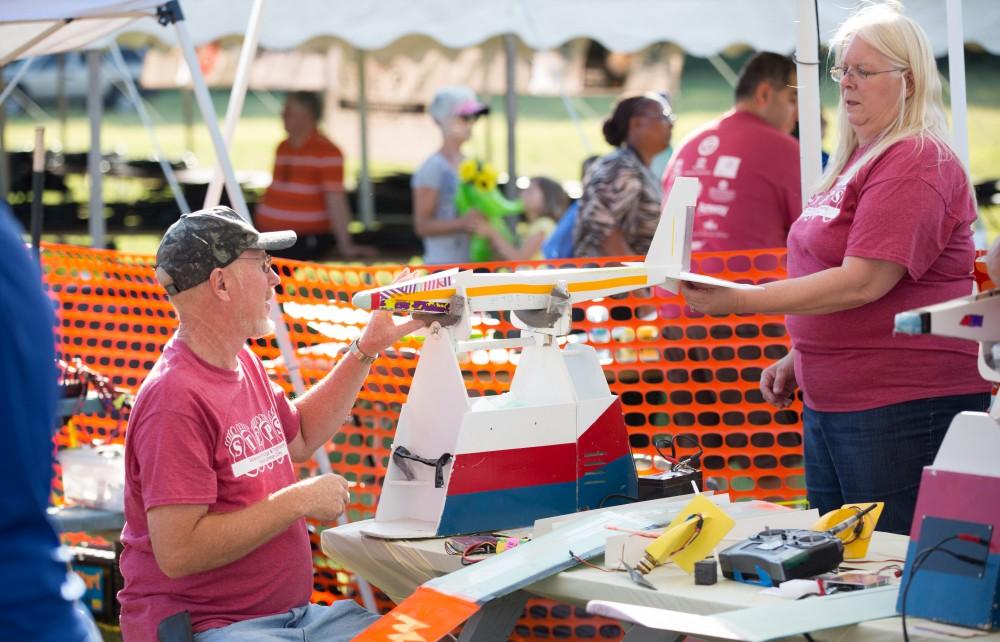 GVL / Kevin Sielaff - Students of STEPS (Science, Technology, and Engineering Day Camps) fly planes that they have built during camp at Warped Wings Fly Field in Allendale on Thursday, June 23, 2016. 