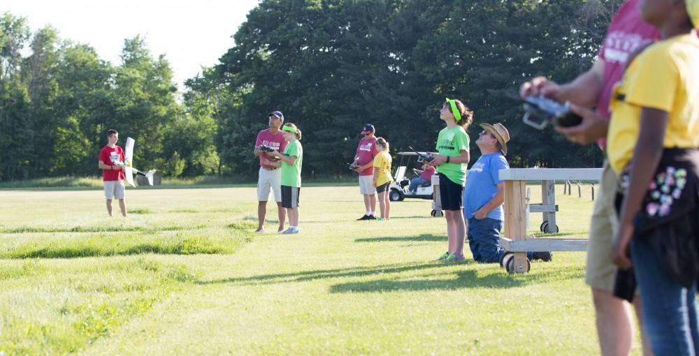 GVL / Kevin Sielaff - Students of STEPS (Science, Technology, and Engineering Day Camps) fly planes that they have built during camp at Warped Wings Fly Field in Allendale on Thursday, June 23, 2016. 