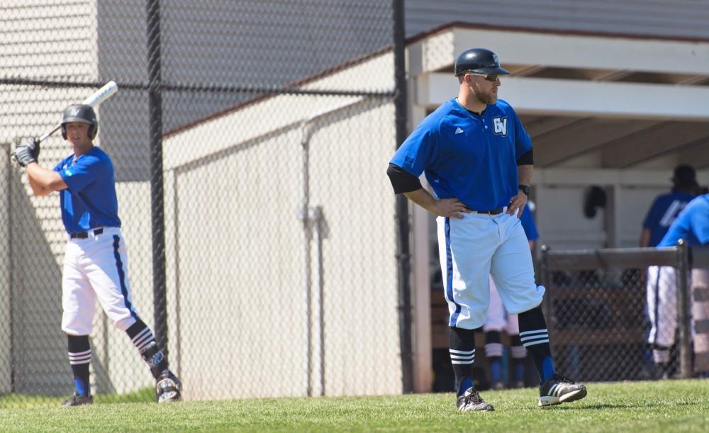 GVL/Luke Holmes - Assistant Coach, Cody Grice, watches his players between innings. Grand Valley Men’s Baseball lost to Walsh college 3-4 in the first game but won 15-8 in the second game.