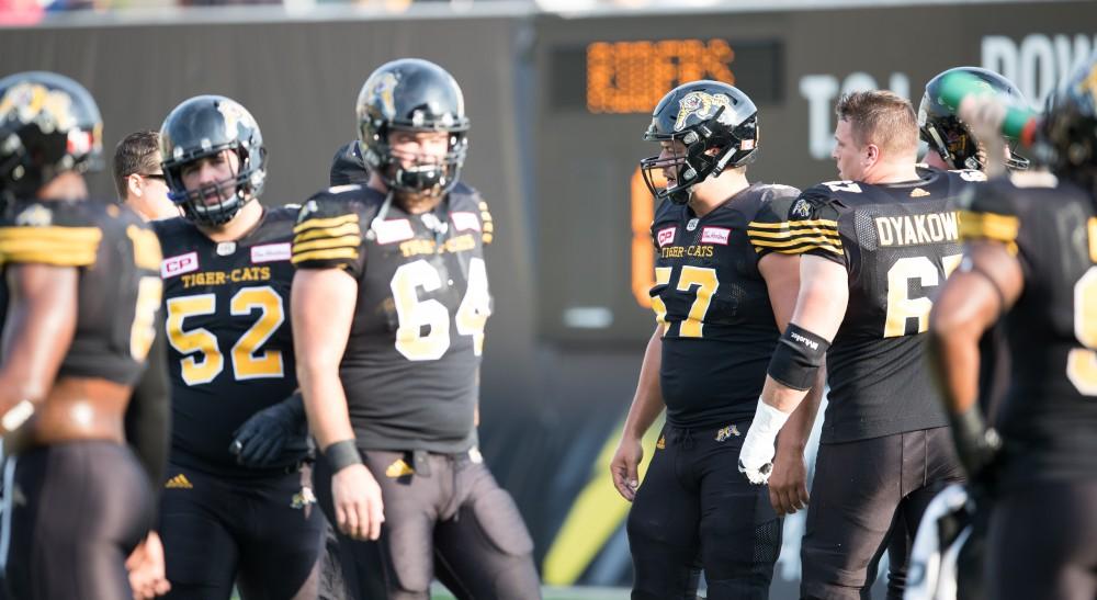 GVL/Kevin Sielaff - Brandon Revenberg (57) runs drills before the start of the match. The Hamilton Tiger-Cats square off against the Saskatchewan Roughriders Saturday, August 20, 2016 in Hamilton, Ontario. 