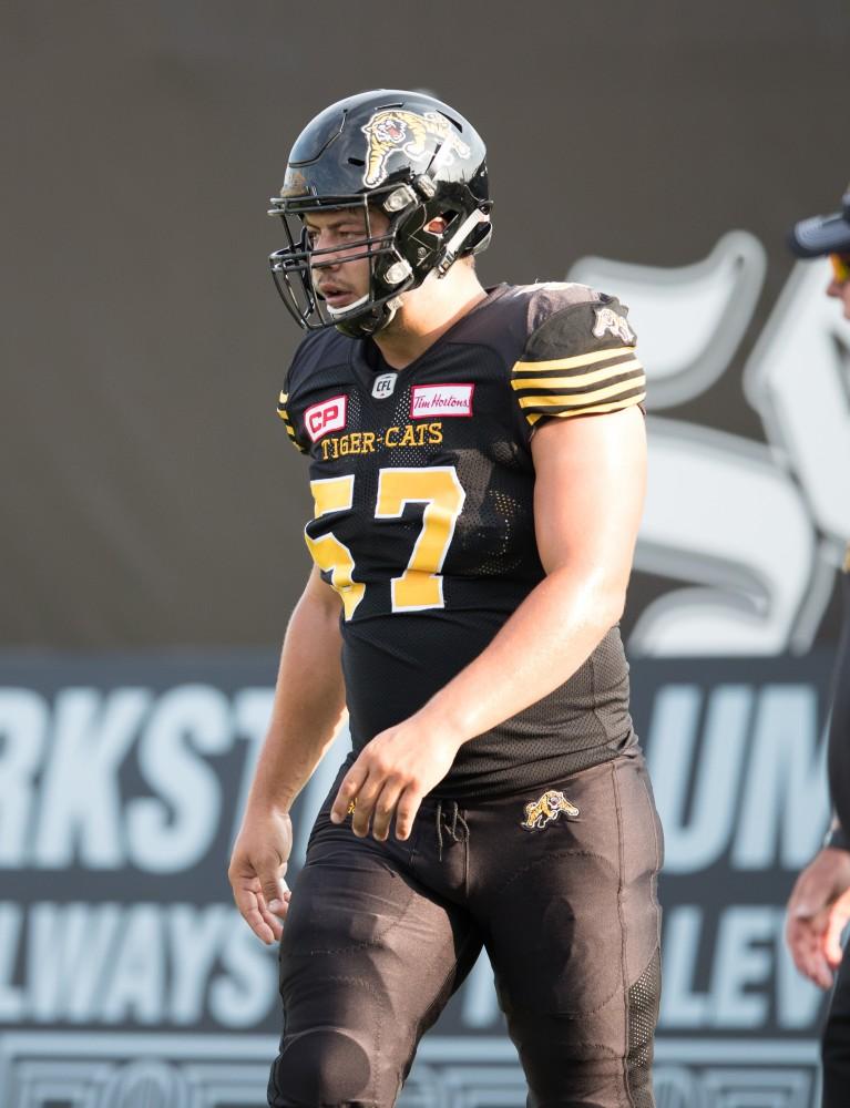 GVL/Kevin Sielaff - Brandon Revenberg (57) runs drills before the start of the match. The Hamilton Tiger-Cats square off against the Saskatchewan Roughriders Saturday, August 20, 2016 in Hamilton, Ontario. 