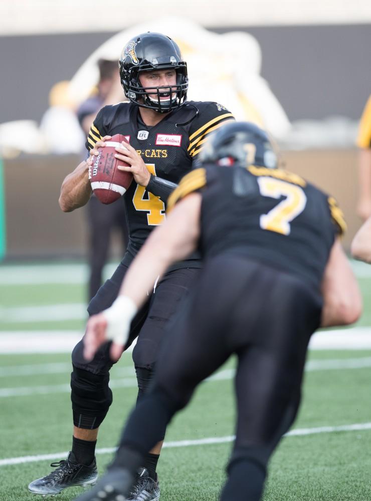 GVL/Kevin Sielaff - Zach Collaros (4) warms up his arm before the start of the match. The Hamilton Tiger-Cats square off against the Saskatchewan Roughriders Saturday, August 20, 2016 in Hamilton, Ontario. 