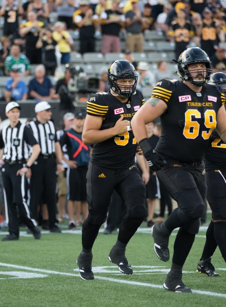 GVL/Kevin Sielaff - Brandon Revenberg (57) and the Tiger-Cats take the field. The Hamilton Tiger-Cats square off against the Saskatchewan Roughriders Saturday, August 20, 2016 in Hamilton, Ontario. 