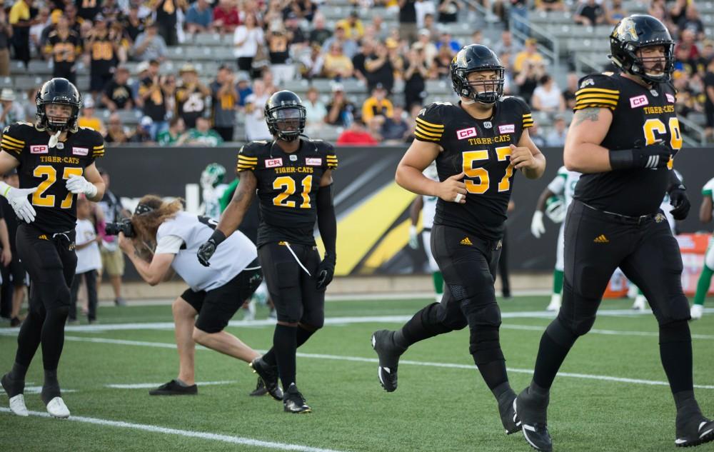 GVL/Kevin Sielaff - Brandon Revenberg (57) and the Tiger-Cats take the field. The Hamilton Tiger-Cats square off against the Saskatchewan Roughriders Saturday, August 20, 2016 in Hamilton, Ontario. 