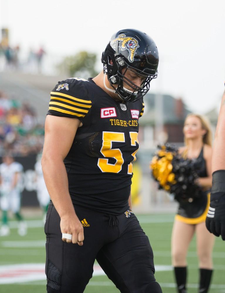 GVL/Kevin Sielaff - Brandon Revenberg (57) and the Tiger-Cats take the field. The Hamilton Tiger-Cats square off against the Saskatchewan Roughriders Saturday, August 20, 2016 in Hamilton, Ontario. 