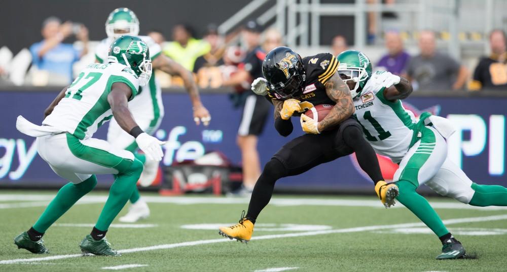 GVL/Kevin Sielaff - Chad Owens (2) receives a pass and bunkers down before he is tackled to the turf. The Hamilton Tiger-Cats square off against the Saskatchewan Roughriders Saturday, August 20, 2016 in Hamilton, Ontario. 