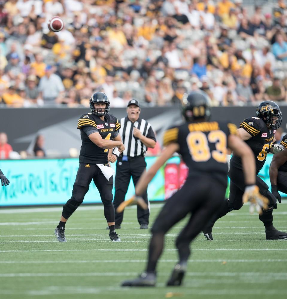 GVL/Kevin Sielaff - Zach Collaros (4) rips a pass to Andy Fantuz (83). The Hamilton Tiger-Cats square off against the Saskatchewan Roughriders Saturday, August 20, 2016 in Hamilton, Ontario. 