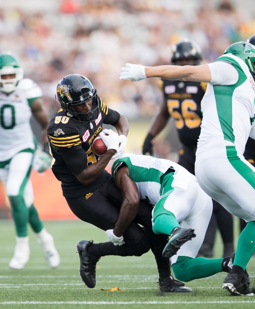 GVL/Kevin Sielaff - Terrence Toliver (80) receives a pass and is immediately tackled. The Hamilton Tiger-Cats square off against the Saskatchewan Roughriders Saturday, August 20, 2016 in Hamilton, Ontario. 