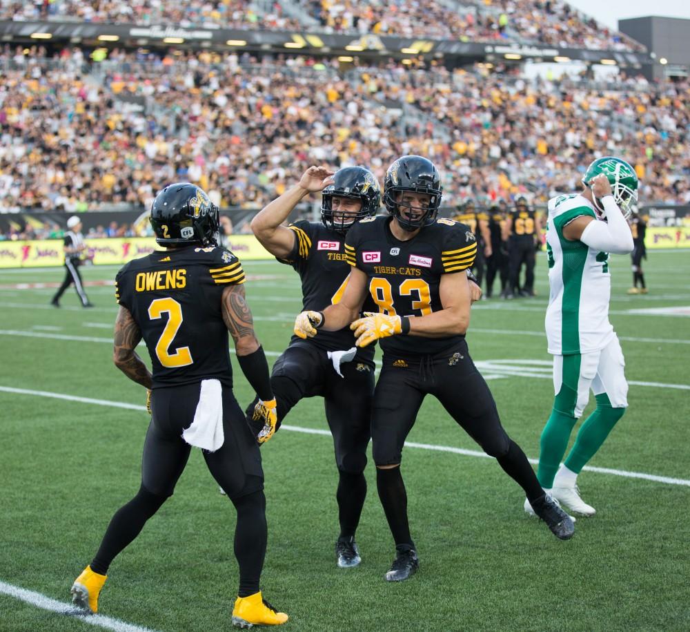 GVL/Kevin Sielaff - QB Zach Collaros (4), WR Chad Owens (2), and WR Andy Fantuz (83) celebrate a touchdown. The Hamilton Tiger-Cats square off against the Saskatchewan Roughriders Saturday, August 20, 2016 in Hamilton, Ontario. 