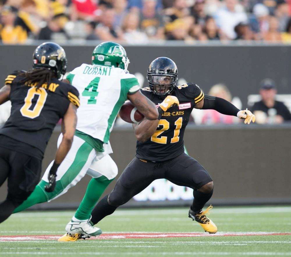 GVL/Kevin Sielaff - Simoni Lawrence (21) jukes in front of opposing QB Darian Durant (4) to make the tackle. The Hamilton Tiger-Cats square off against the Saskatchewan Roughriders Saturday, August 20, 2016 in Hamilton, Ontario. 