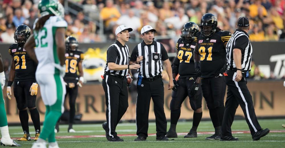 GVL/Kevin Sielaff - Referees discuss a penalty on the field. The Hamilton Tiger-Cats square off against the Saskatchewan Roughriders Saturday, August 20, 2016 in Hamilton, Ontario. 