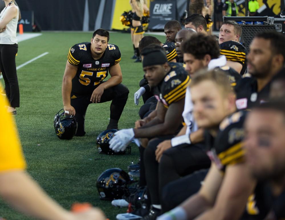 GVL/Kevin Sielaff - Brandon Revenberg (57) rests on the sideline in between plays. The Hamilton Tiger-Cats square off against the Saskatchewan Roughriders Saturday, August 20, 2016 in Hamilton, Ontario. 