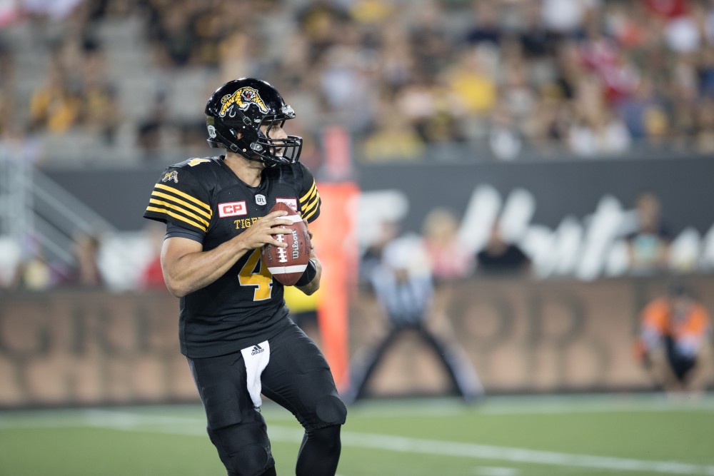 GVL/Kevin Sielaff - Zach Collaros (4) steps back in the pocket and looks to pass the ball down field. The Hamilton Tiger-Cats square off against the Saskatchewan Roughriders Saturday, August 20, 2016 in Hamilton, Ontario. 