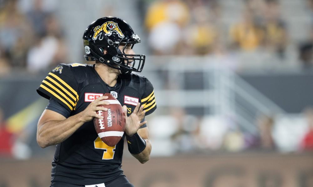 GVL/Kevin Sielaff - Zach Collaros (4) steps back in the pocket and looks to pass the ball down field. The Hamilton Tiger-Cats square off against the Saskatchewan Roughriders Saturday, August 20, 2016 in Hamilton, Ontario. 