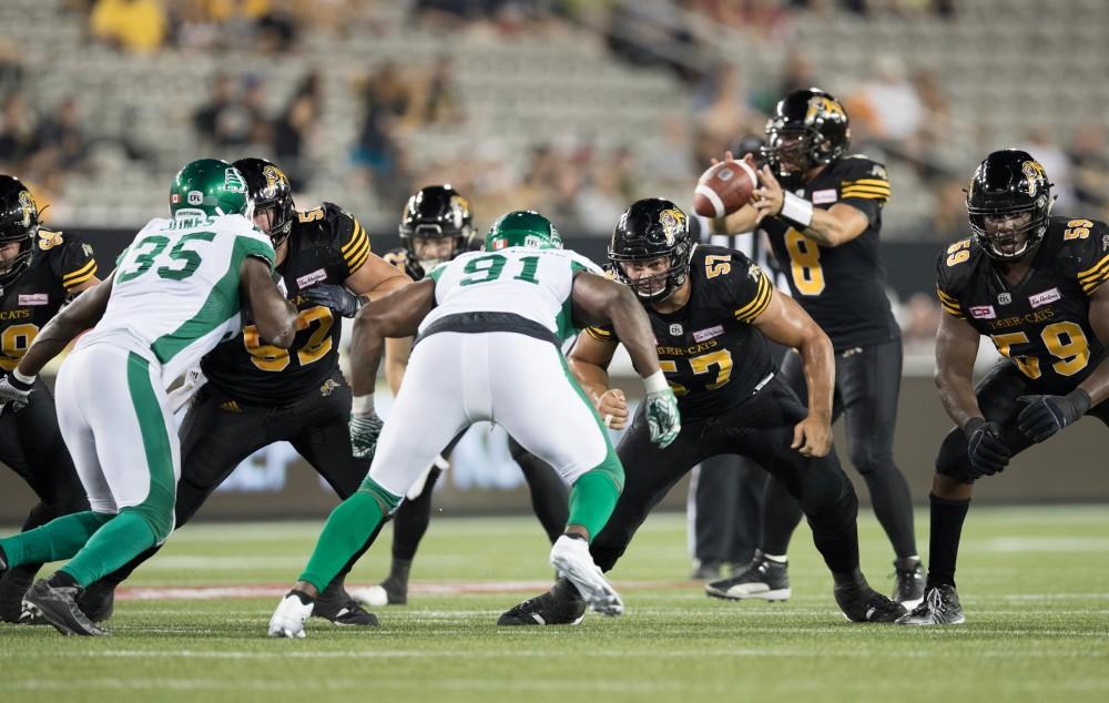 GVL/Kevin Sielaff - Brandon Revenberg (57) holds offensive line. The Hamilton Tiger-Cats square off against the Saskatchewan Roughriders Saturday, August 20, 2016 in Hamilton, Ontario. 