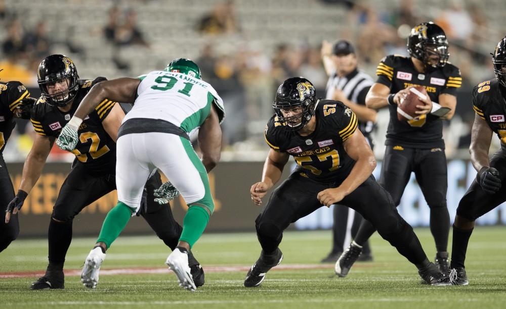 GVL/Kevin Sielaff - Brandon Revenberg (57) holds offensive line. The Hamilton Tiger-Cats square off against the Saskatchewan Roughriders Saturday, August 20, 2016 in Hamilton, Ontario. 