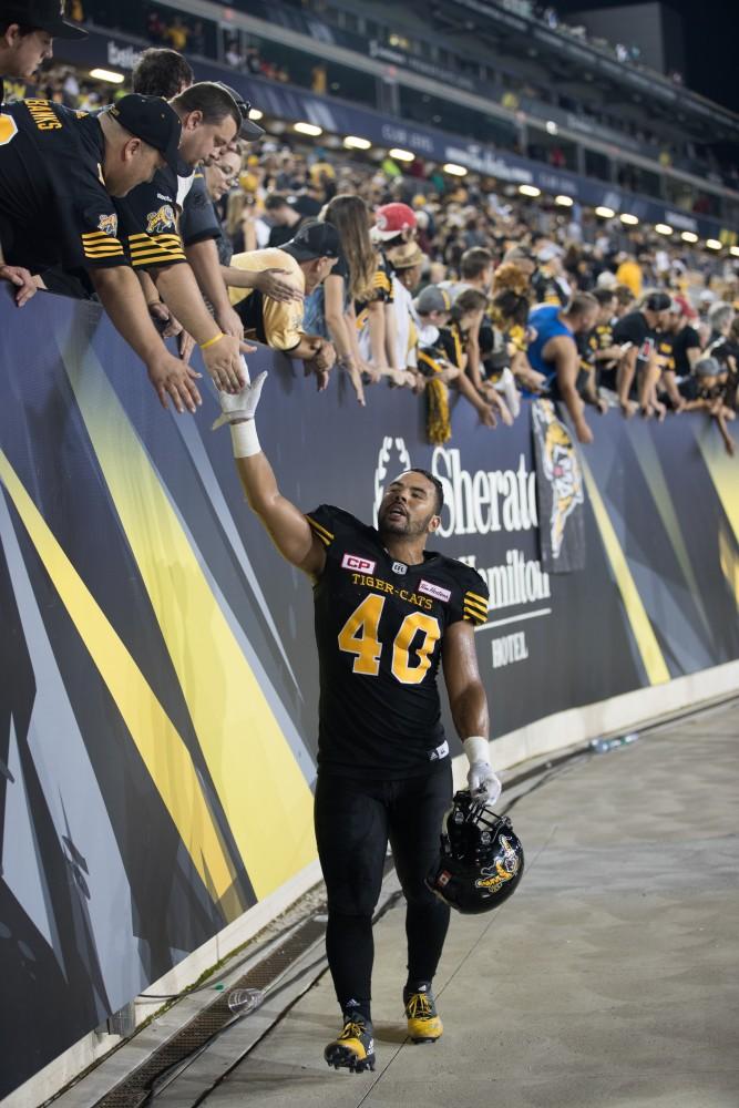 GVL/Kevin Sielaff - Terrell Davis (40) high-fives fans after the match. The Hamilton Tiger-Cats square off against the Saskatchewan Roughriders Saturday, August 20, 2016 in Hamilton, Ontario. 