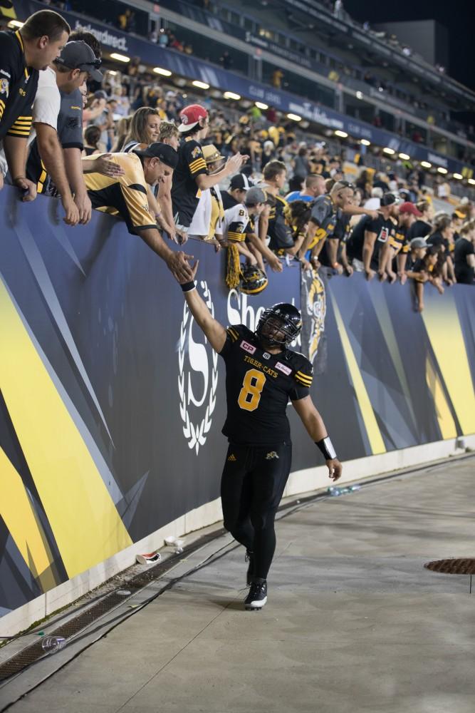 GVL/Kevin Sielaff - Jeremiah Masoli (8) high-fives fans after the match. The Hamilton Tiger-Cats square off against the Saskatchewan Roughriders Saturday, August 20, 2016 in Hamilton, Ontario. 