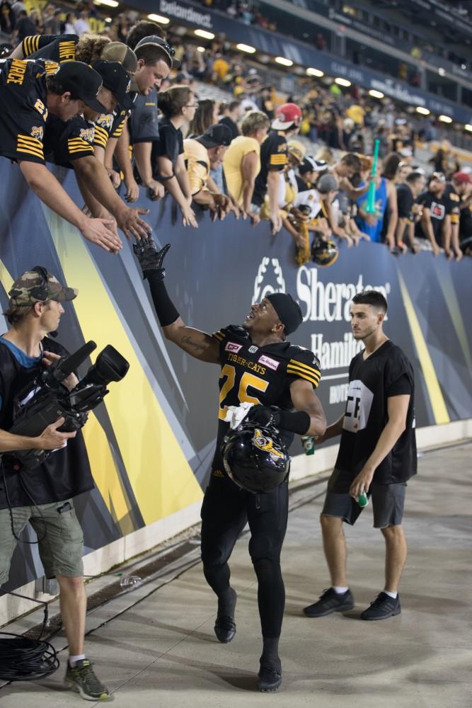 GVL/Kevin Sielaff - Chris Davis high-fives fans after the match. The Hamilton Tiger-Cats square off against the Saskatchewan Roughriders Saturday, August 20, 2016 in Hamilton, Ontario. 