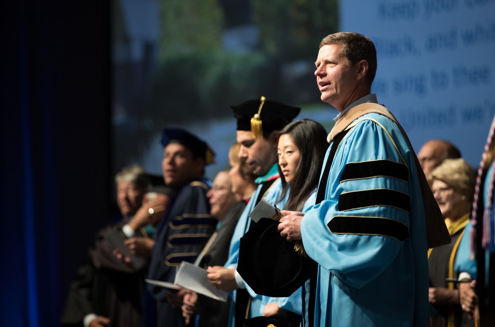 GVL/Kevin Sielaff - David Hooker recites the alma mater at Grand Valley's annual Convocation ceremonies on Friday, August 26, 2016.