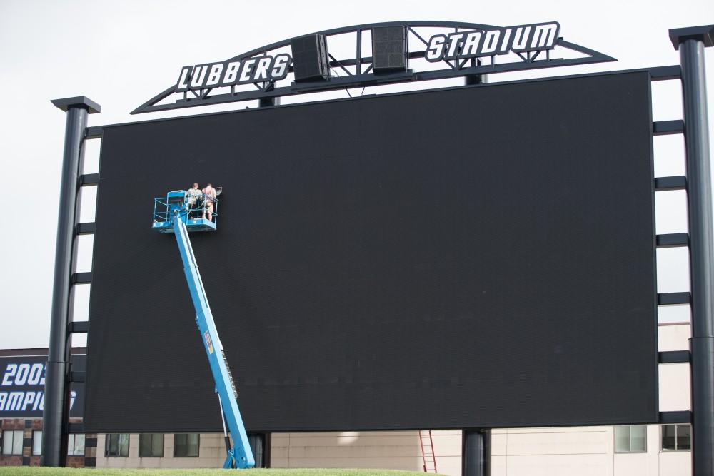 GVL / Kevin Sielaff - Workers put the final touches on Lubbers Stadium's new video board. Grand Valley State football hosts its annual media day at Lubbers Stadium on Thursday, August 25, 2016. 