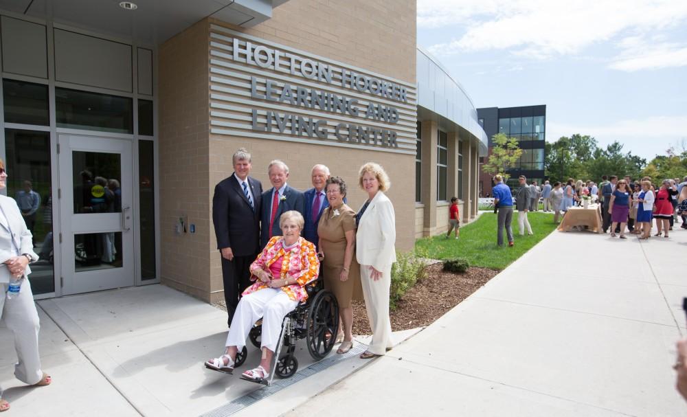 GVL/Kevin Sielaff - President Thomas Haas and his wife Marcia Haas stand with the Holton and Hooker families in front of the Holton-Hooker Learning and Living Center on Friday, August 26, 2016.   